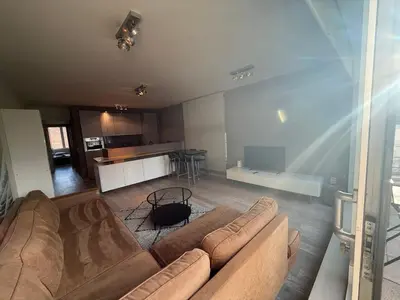 a living room with a couch and a kitchen at Apartment with 2 Bedrooms - Sleeps 6 in Brussels