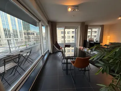 a room with a balcony with a table and chairs at Stunning Apartment with 2 Bedrooms - Sleeps 6 in Brussels