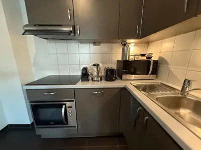 a small kitchen with a sink and a microwave at Stunning Apartment with 2 Bedrooms - Sleeps 6 in Brussels