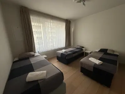 a hotel room with two beds and a window at Stunning Apartment with 2 Bedrooms - Sleeps 6 in Brussels