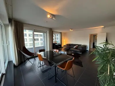 a living room with a table and chairs and a couch at Stunning Apartment with 2 Bedrooms - Sleeps 6 in Brussels