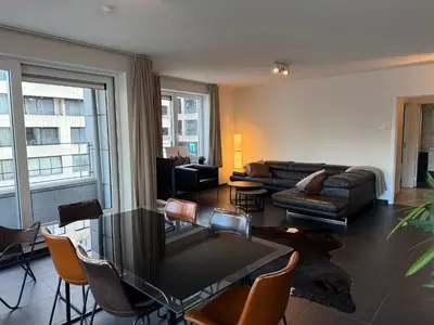 a living room with a couch and a table and chairs at Stunning Apartment with 2 Bedrooms - Sleeps 6 in Brussels