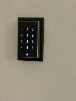 a black remote control on a wall at L'Excelsior Suites in Brasschaat
