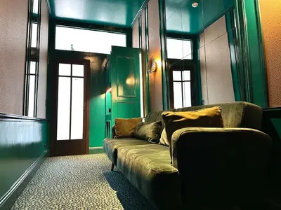 a living room with a couch in front of a door at Sablon Muse Apartment in Brussels
