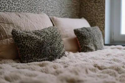 a bed with two pillows on top of it at Sablon Muse Apartment in Brussels