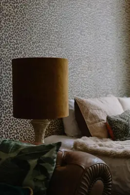 a lamp sitting on a couch next to a bed at Sablon Muse Apartment in Brussels