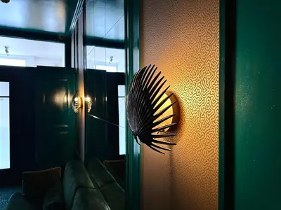 a fan on a wall next to a couch at Sablon Muse Apartment in Brussels
