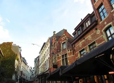 a city street with tall brick buildings at Sablon Muse Apartment in Brussels