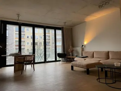 a living room with a couch and a table at Luxury apartment with a view of the MAS in Antwerp