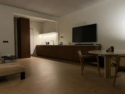 a living room with a flat screen tv and a table at Luxury apartment with a view of the MAS in Antwerp