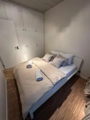 a bedroom with a large bed with two pillows on it at Luxury apartment with a view of the MAS in Antwerp