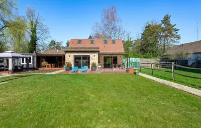 a house with a large yard in front of it at Beautiful Home In Arendonk With Sauna in Arendonk