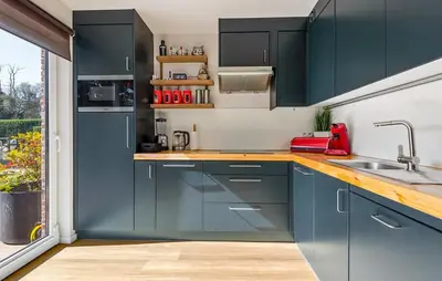 a kitchen with blue cabinets and a sink at Beautiful Home In Arendonk With Sauna in Arendonk