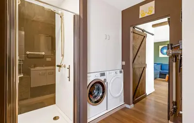 a laundry room with a washer and dryer in a house at Beautiful Home In Arendonk With Sauna in Arendonk