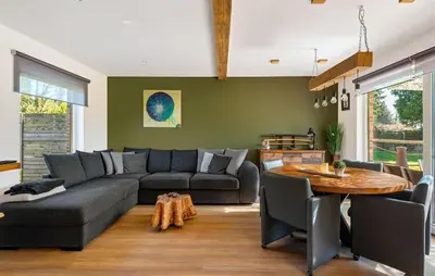 a living room with a couch and a table at Beautiful Home In Arendonk With Sauna in Arendonk