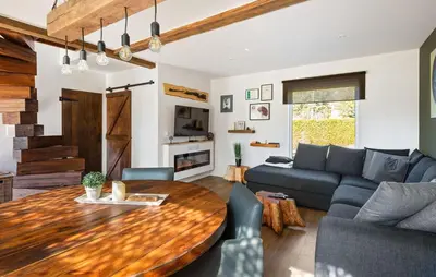 a living room with a wooden table and a couch at Beautiful Home In Arendonk With Sauna in Arendonk