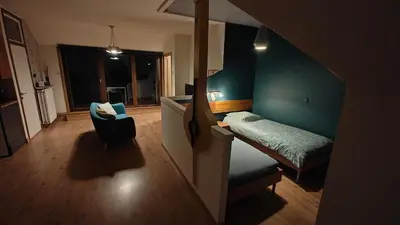 a small room with a bed and a chair at Klik Klak Studio in Bornem