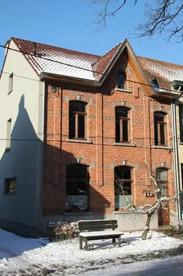 a brick building with a bench in front of it at Klik Klak Studio in Bornem