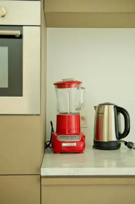 a red blender sitting on top of a kitchen counter at Maison Gustave in Ghent