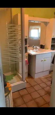 a kitchen with a sink and a glass shower door at Tomorrowland in Rumst