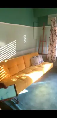 a large couch in a room with a window at Tomorrowland in Rumst