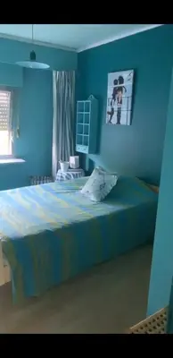 a blue bedroom with a bed and a blue wall at Tomorrowland in Rumst