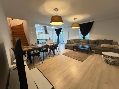 a living room with a couch and a table at Grande Maison entière 5 chambre Zaventem in Zaventem