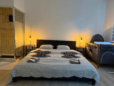 a bedroom with a large bed with towels on it at Grande Maison entière 5 chambre Zaventem in Zaventem