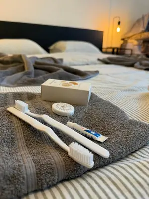 a bed with two toothbrushes and a box of toothpaste at Grande Maison entière 5 chambre Zaventem in Zaventem