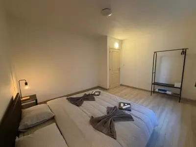 a bedroom with a large bed with two towels on it at Grande Maison entière 5 chambre Zaventem in Zaventem