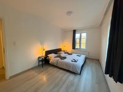 a bedroom with a bed and a window at Grande Maison entière 5 chambre Zaventem in Zaventem