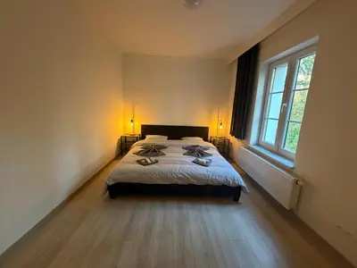 a bedroom with a bed and a large window at Grande Maison entière 5 chambre Zaventem in Zaventem