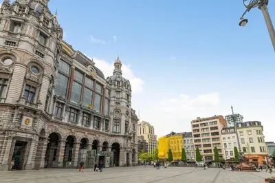 a large building with people walking in front of it at Apartment in the center of Antwerp in Antwerp