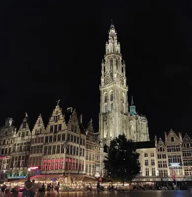 a large building with a clock tower at night at Apartment in the center of Antwerp in Antwerp