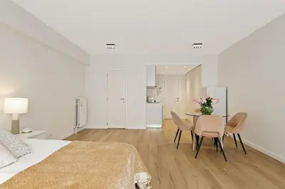 a bedroom with a bed and a table and chairs at Apartment in the center of Antwerp in Antwerp