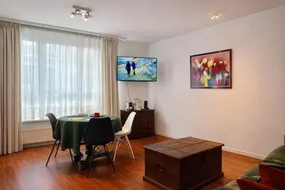 a living room with a table and a couch at Alhambra hideaway prime location in Brussels