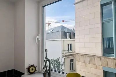 a window with a view of a building at Alhambra hideaway prime location in Brussels