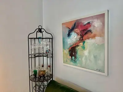 a black glass shelf next to a painting on the wall at Alhambra hideaway prime location in Brussels