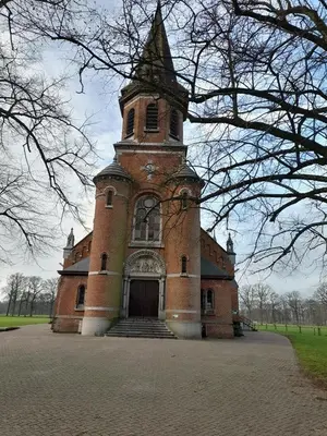 a large brick building with a tower on top at De Spetser in Merksplas