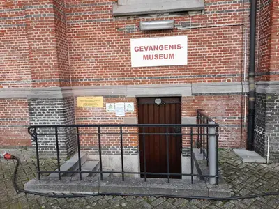 a brick building with a door with a sign on it at De Spetser in Merksplas
