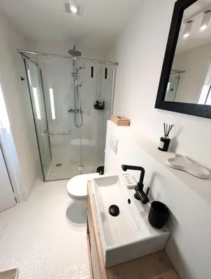 a white bathroom with a shower and a sink at Libertypenthouseghent - Monthly Stays - Miljoenenkwartier Gent in Ghent