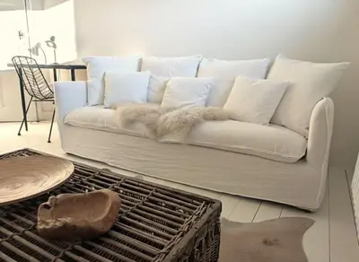 a white couch sitting in a living room at Libertypenthouseghent - Monthly Stays - Miljoenenkwartier Gent in Ghent