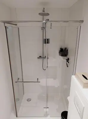 a shower with a glass door in a bathroom at Libertypenthouseghent - Monthly Stays - Miljoenenkwartier Gent in Ghent