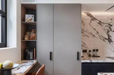 a kitchen with white cabinets and a marble counter top at Superb Apartment Pierson in Brussels