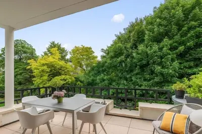 a patio with a table and chairs and trees at Superb Apartment Pierson in Brussels