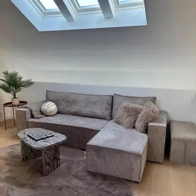 a living room with a couch and a table at Le Cozy Bijou in Antwerp