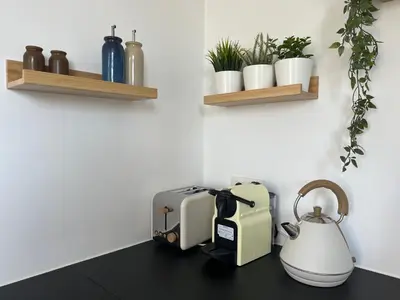 two toasters and a tea kettle on a counter at Le Cozy Bijou in Antwerp