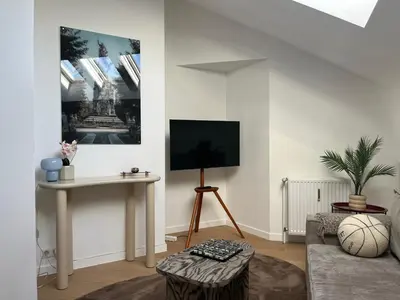 a living room with a tv and a table at Le Cozy Bijou in Antwerp