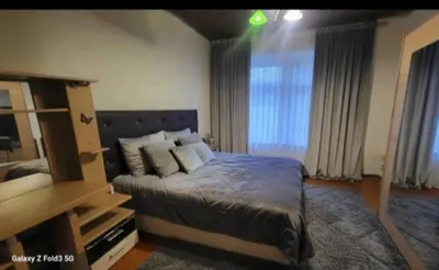 a bedroom with a bed and a dresser and a mirror at appartement Laken Belgique in Brussels