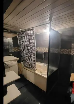 a bathroom with a bath tub and a shower at appartement Laken Belgique in Brussels